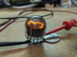 Glowing vintage Nixie tubes on a test bench, the retro numeric display tech used in Nixie clocks