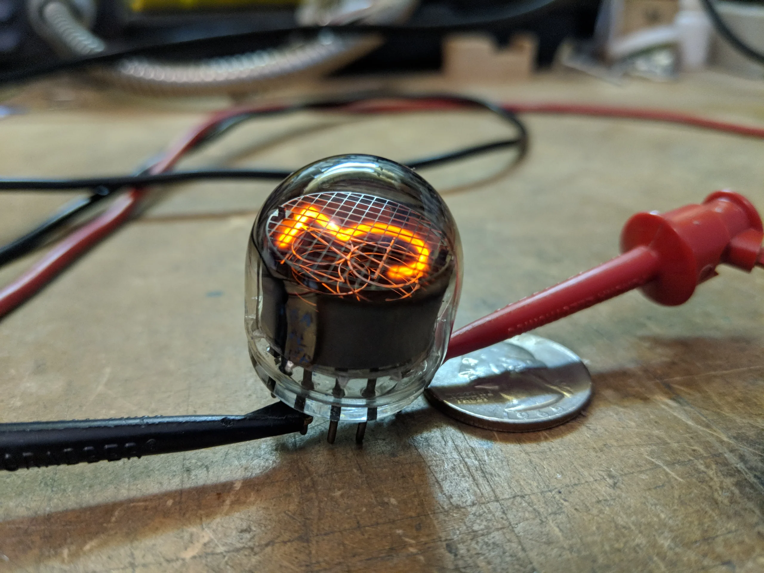 Glowing vintage Nixie tubes on a test bench, the retro numeric display tech used in Nixie clocks