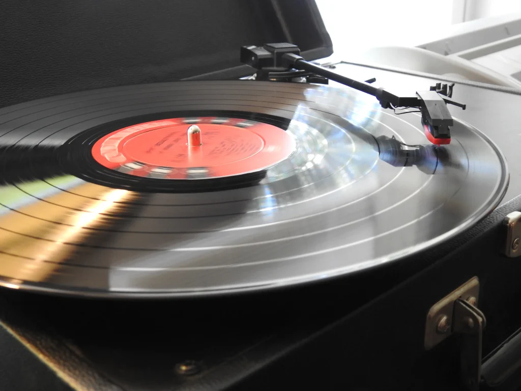 A classic vinyl record player with the turntable spinning, warm analog audio lifestyle