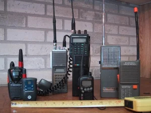 A lineup of vintage recreational walkie-talkies and an amateur radio handset, classic two-way communication devices